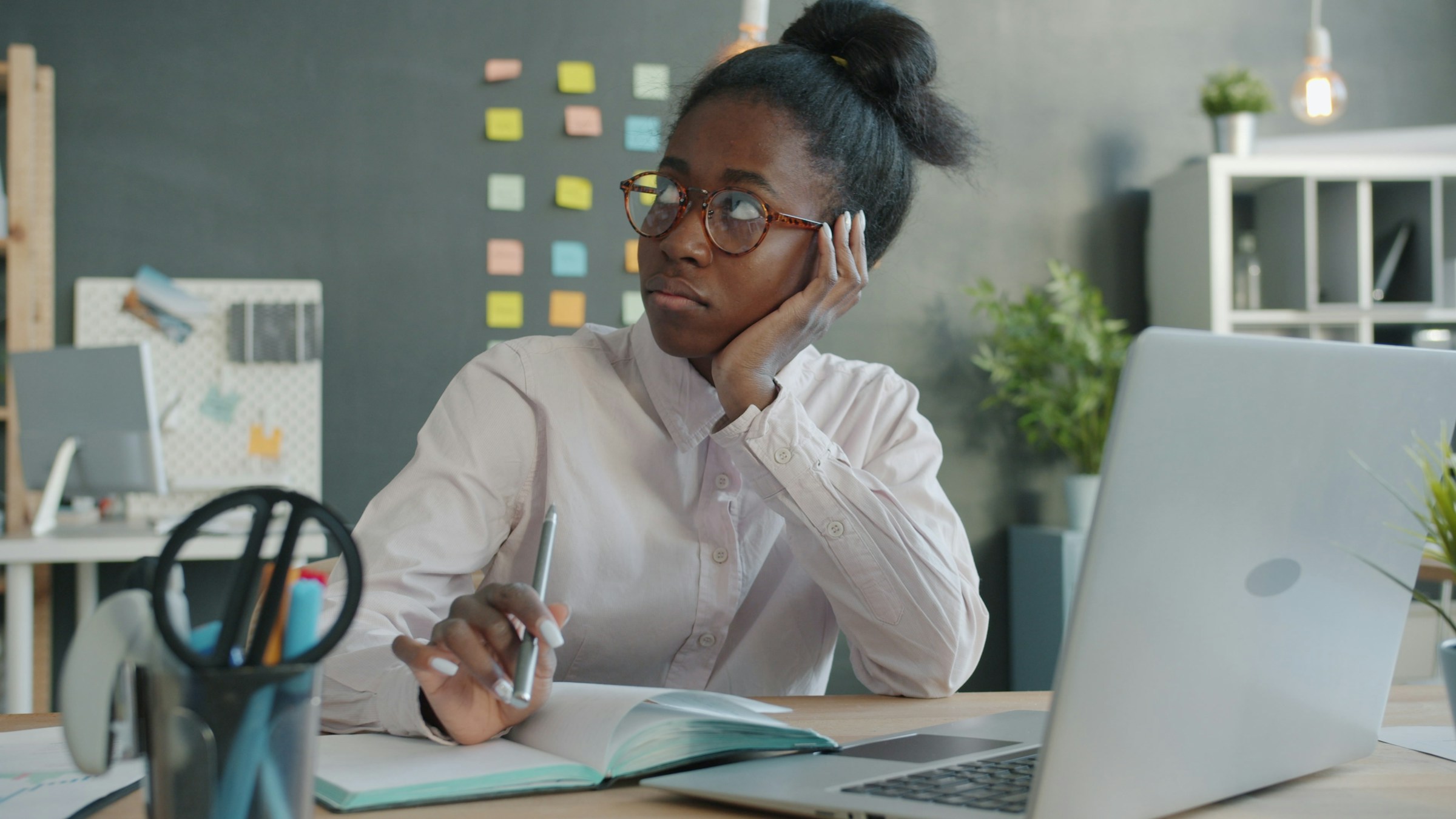 anxious woman in front of computer gazing at wall