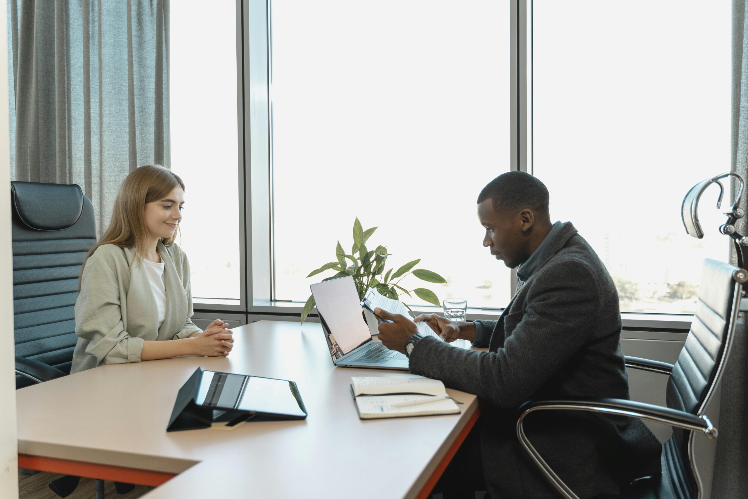 man interviewing woman in office